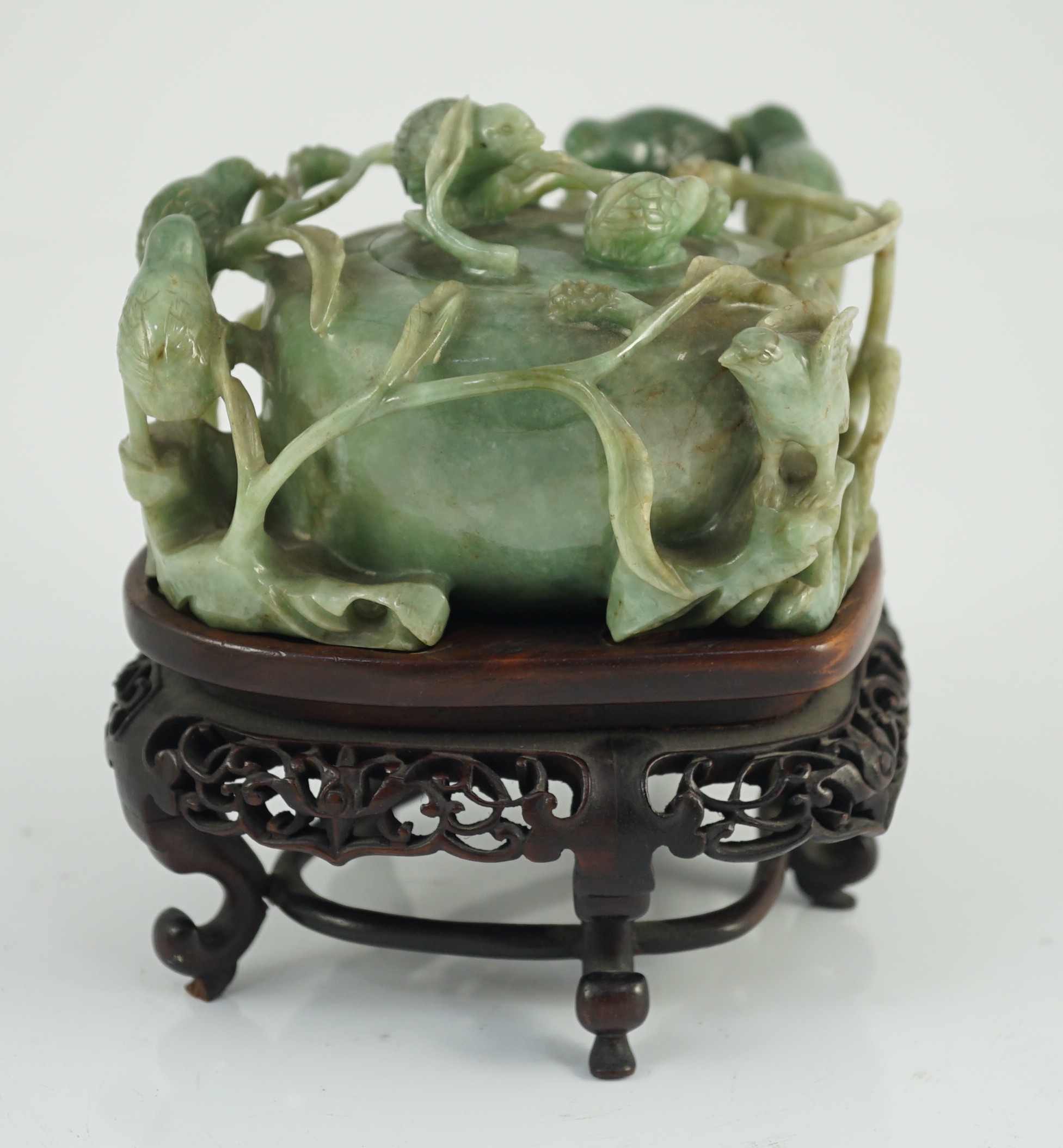 A Chinese jadeite ‘quail and millet’ water pot and stand, late 19th century, original carved and pierced wood stand, total width 15.2cm